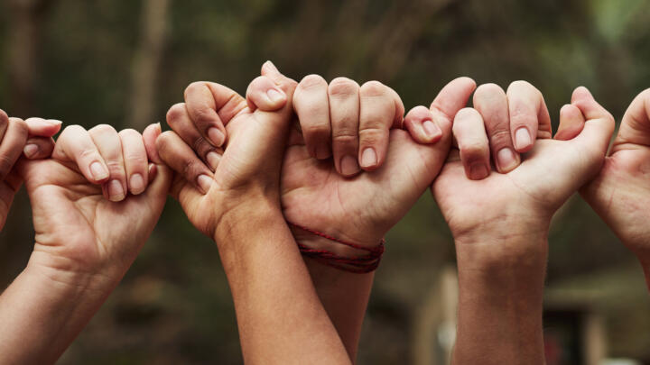 Diverse hands connecting to show the importance of working together.